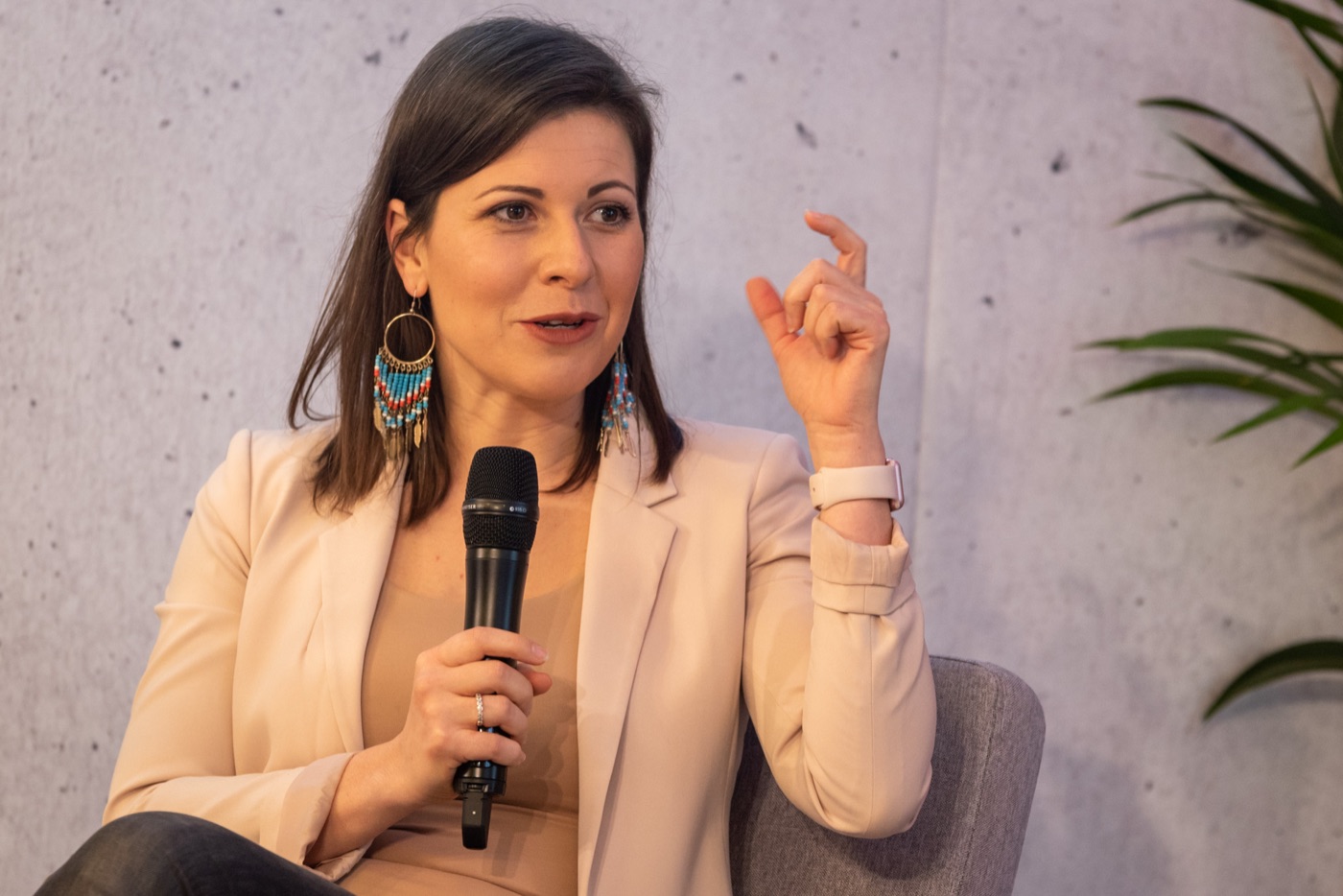 Irma speaking with a microphone during a panel conversation