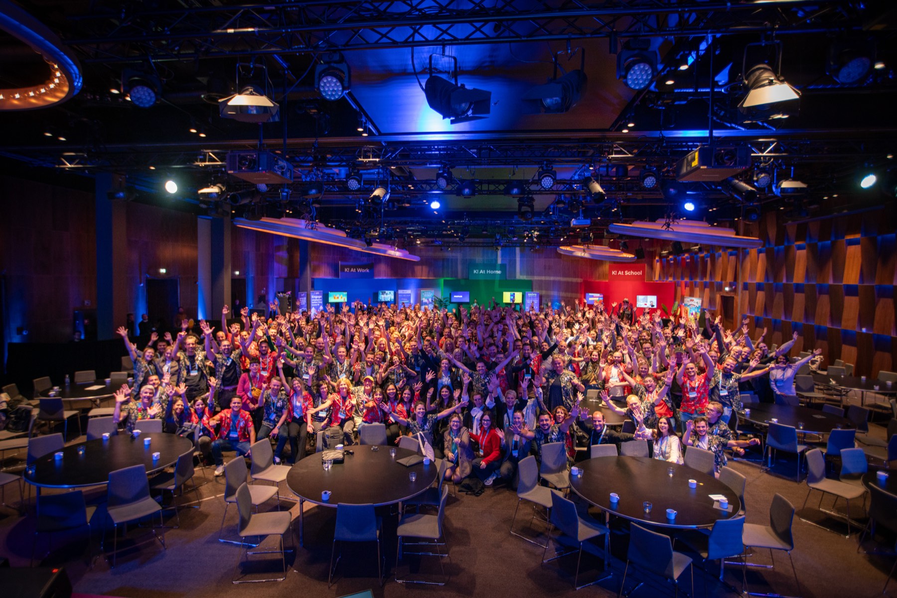 A celebrating audience of several hundred people at a large-scale gathering